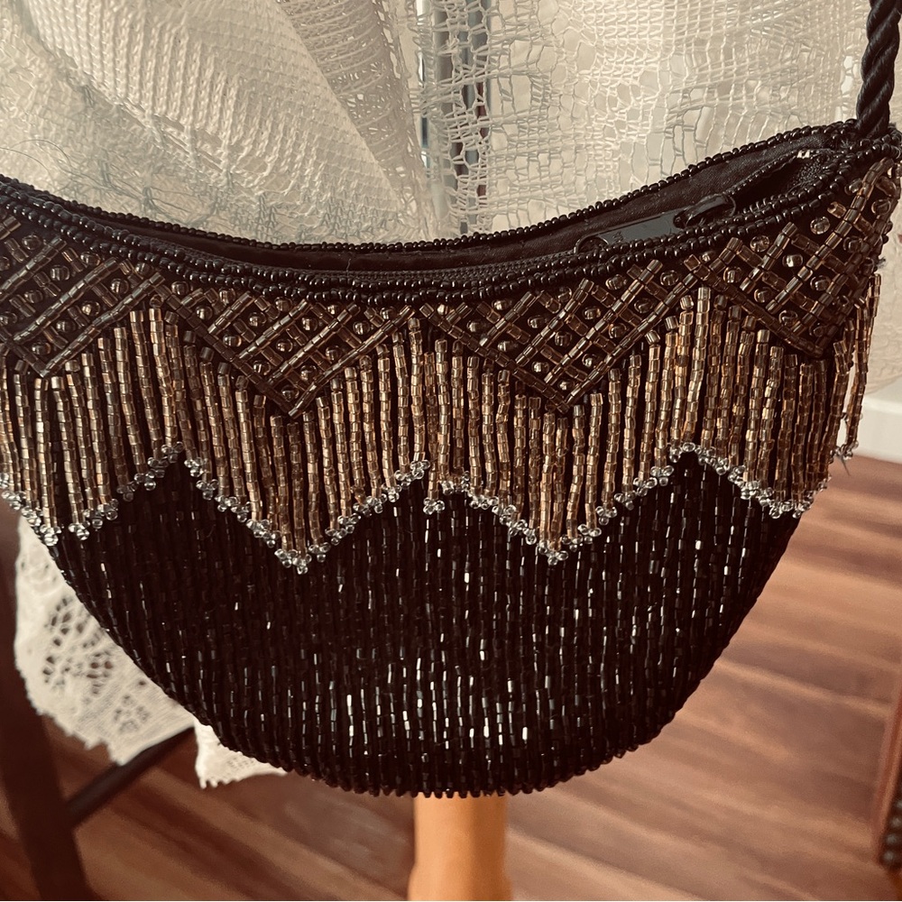 vintage Nina Ricci beaded handbag black and gold beadwork with fringe.